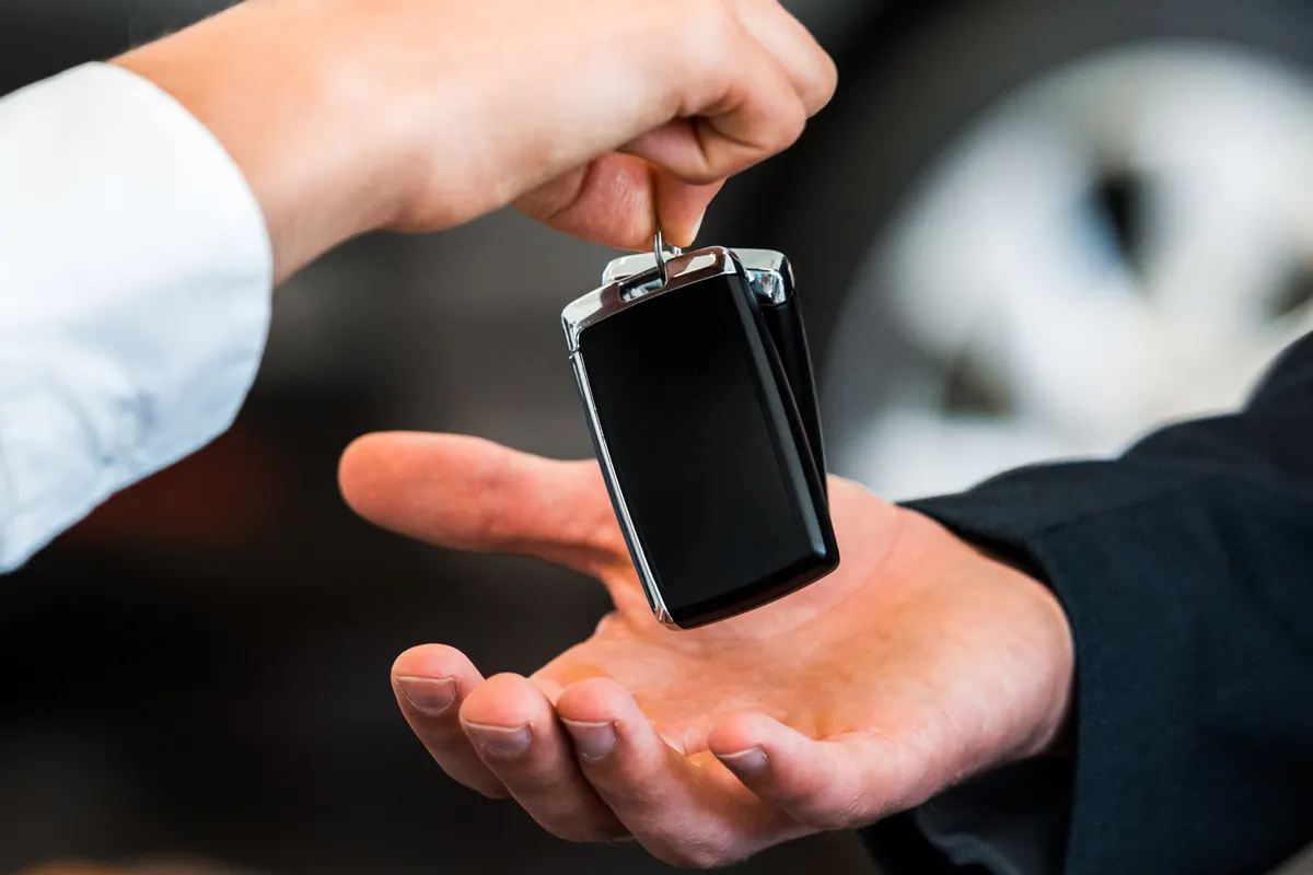 Clé de voiture remise dans la main d’un client